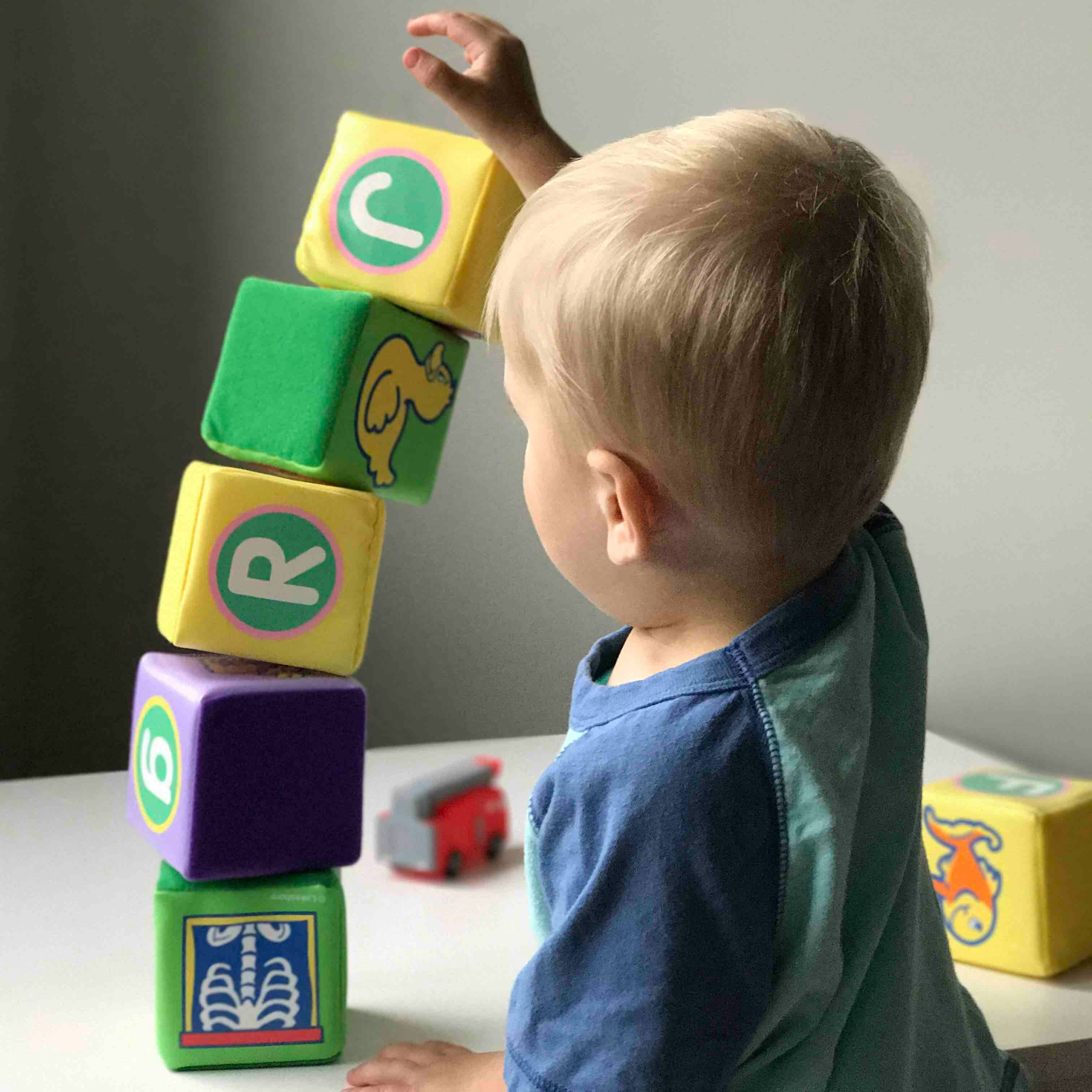 Toddler stacking colorful blocks during independent play