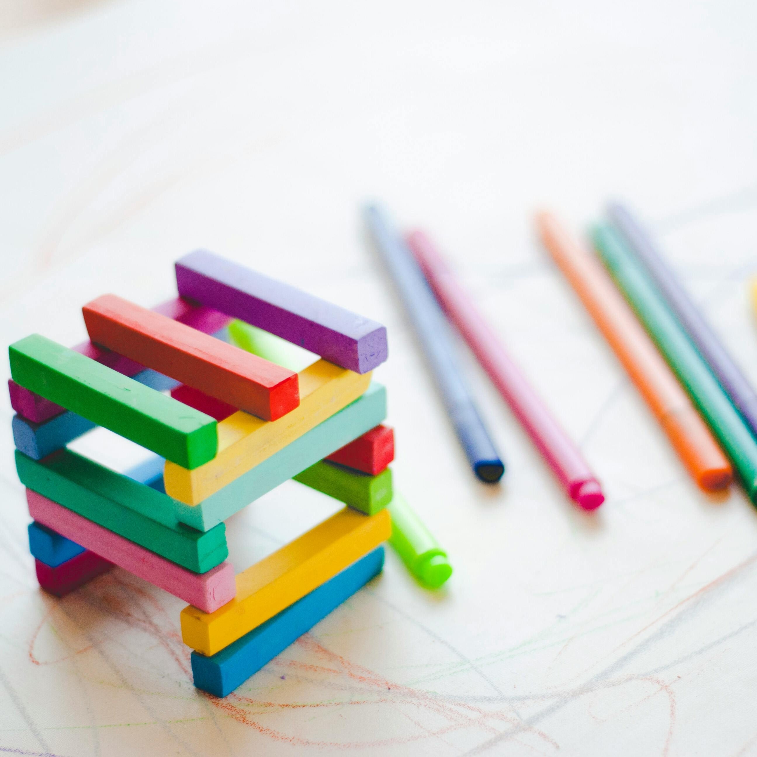 Wooden rainbow stacking toy with colored pencils