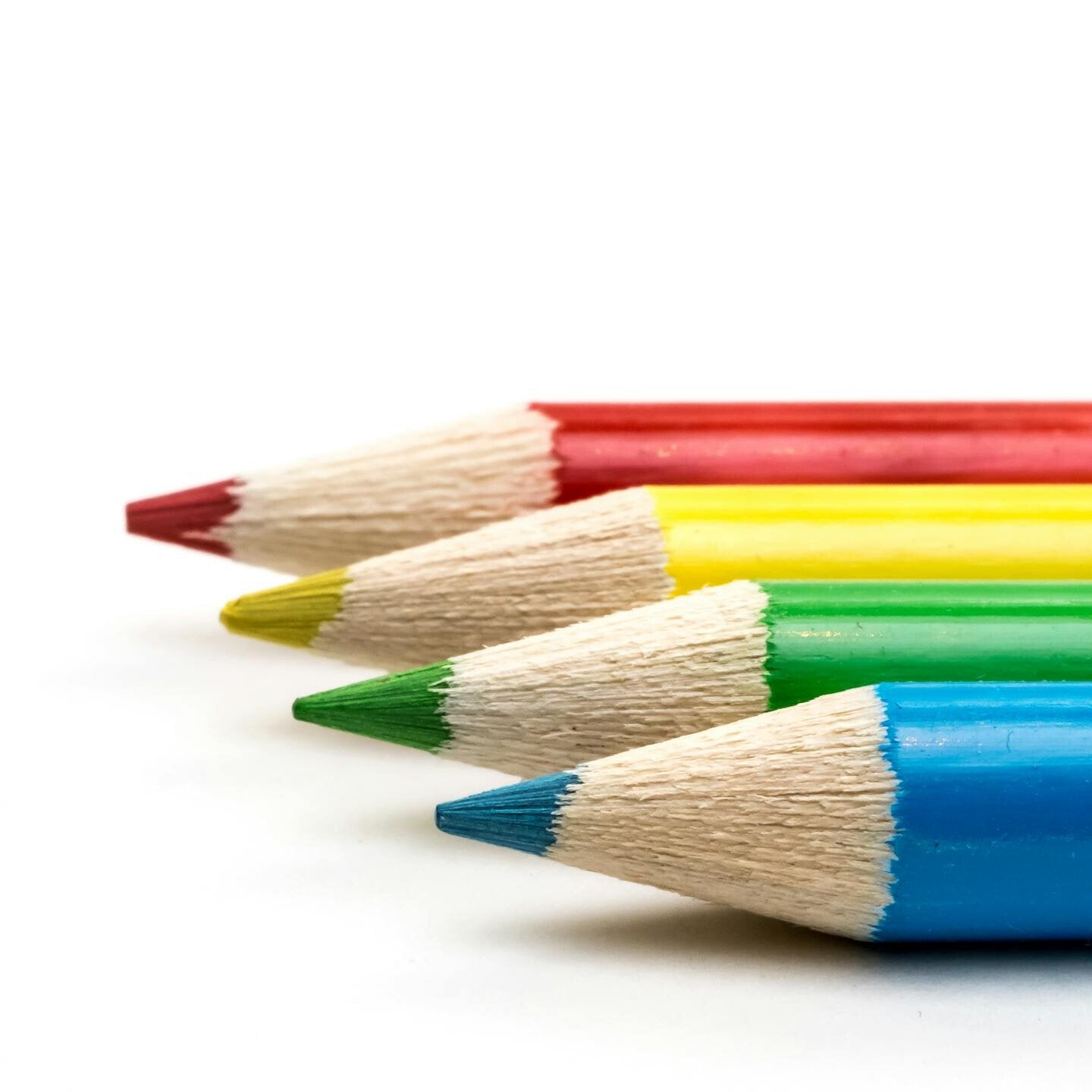 Close-up of sharpened colored pencils in row